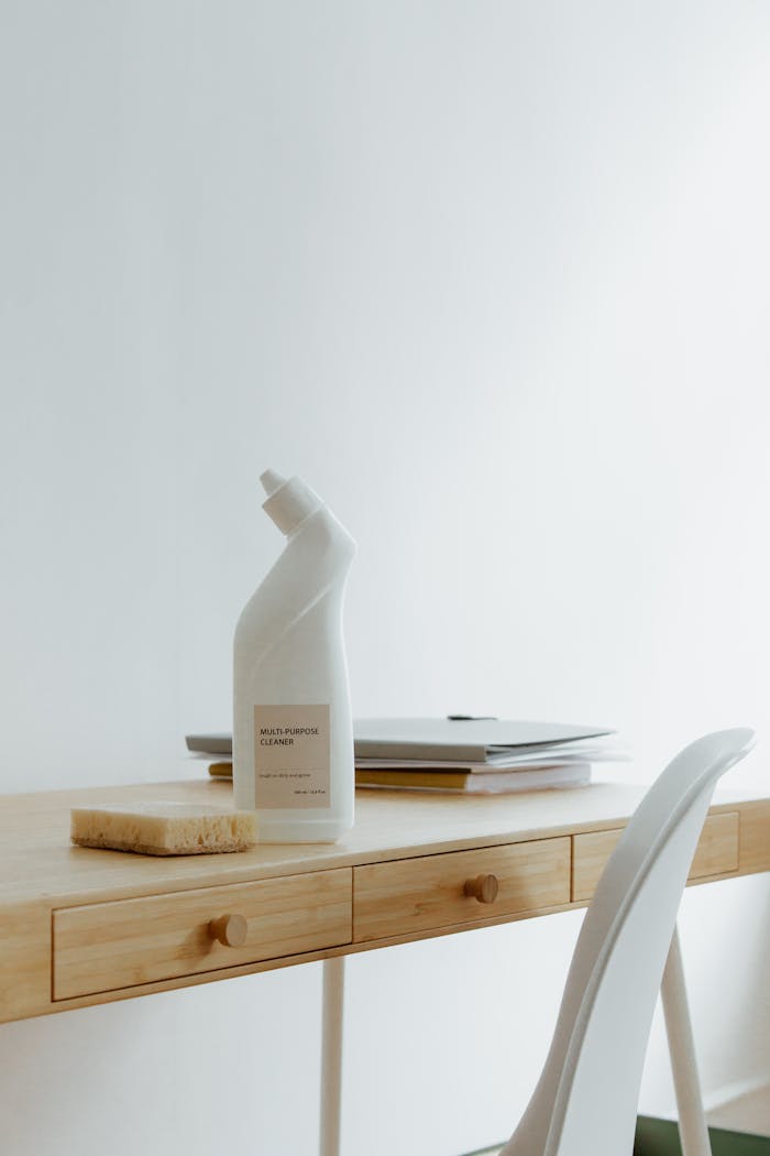 services-01 A clean and organized home office desk with a cleaner bottle and sponge, emphasizing simplicity and functionality.
